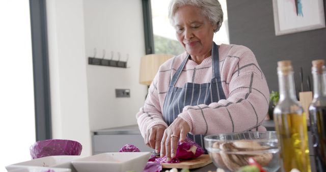 Senior Woman Slicing Vegetables in Modern Kitchen Smiling - Download Free Stock Images Pikwizard.com