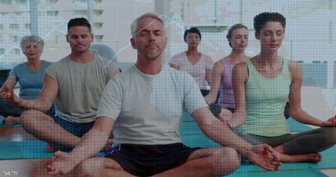 Meditating mature man leading group yoga session with digital data overlay, urban studio