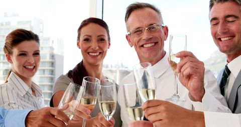 Business Professionals Celebrating Success with Champagne