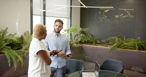 Multiethnic Professionals Collaborating in Modern Office with Technology