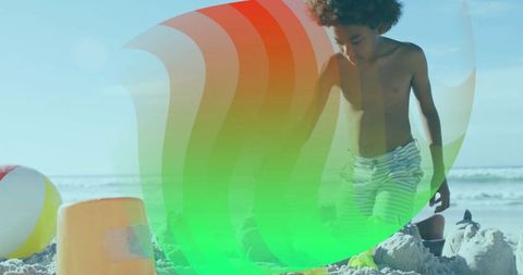 Child building sandcastle at beach with bright colors