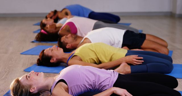 Group Relaxing in Shavasana Pose on Yoga Mats After Meditation Session - Download Free Stock Images Pikwizard.com