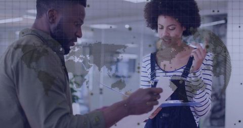 Colleagues reviewing data with futuristic digital overlay in office