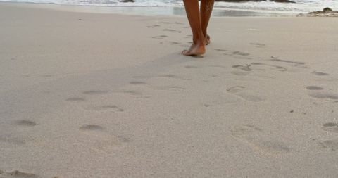 Barefoot Walking on Tranquil Sandy Beach