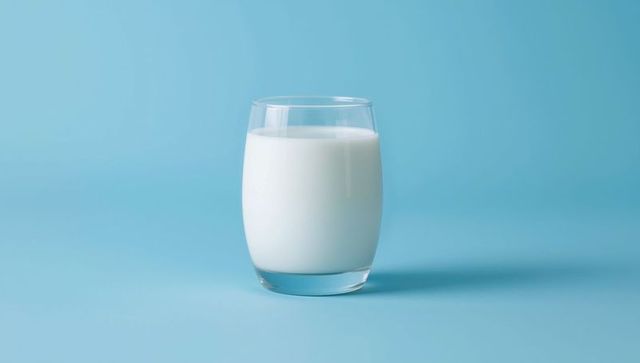 Minimalist Glass of Milk on Soft Blue Background