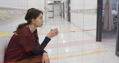 Nurse sitting in corridor holding coffee and stethoscope with data visualization overlay
