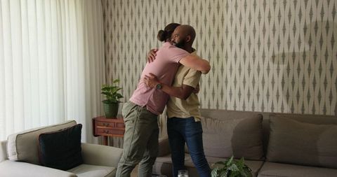 Two friends engaging in thoughtful conversation in comfortable living room