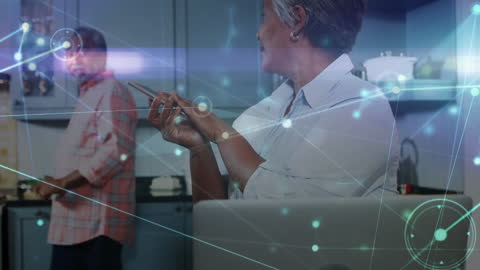 Elderly couple shown interacting with digital graphics overlay, illustrating concept of connectivity and tech integration in daily life. Useful for themes related to technology adoption among seniors, smart home concepts, and global communication networks.