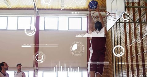 Basketball player dunking with augmented hud analytics in indoor gym competition teamwork