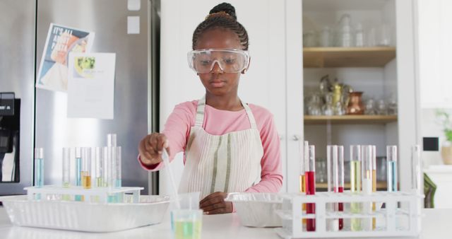 Serious african american girl in safety glasses doing chemistry experiment at home, with copy space - Download Free Stock Photos Pikwizard.com