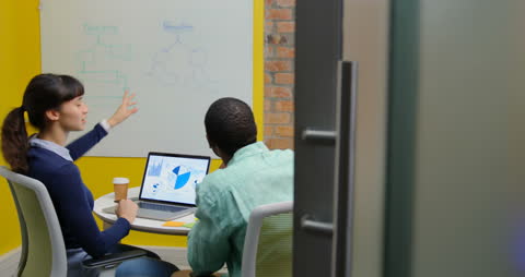 Diverse Team Collaborating on Business Strategy with Charts