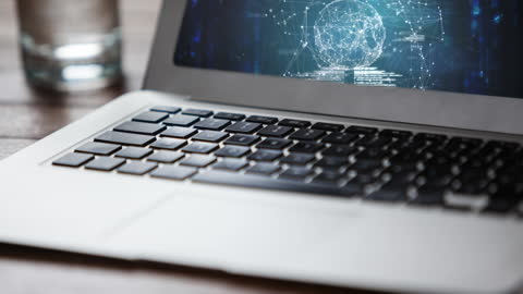 Laptop Displaying Spinning Globe with Digital Connections