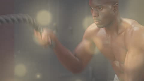 Man Engaging in Intense Battle Rope Workout