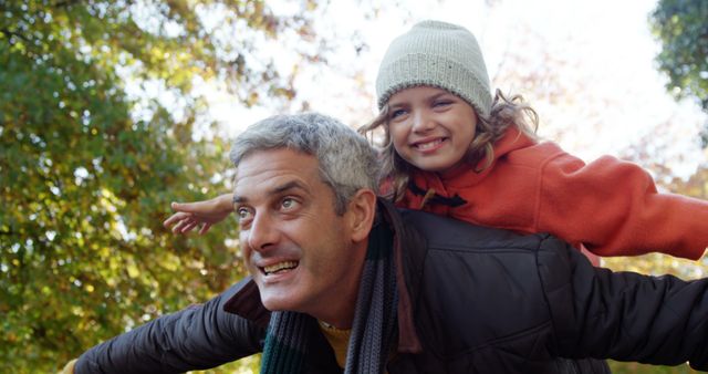 Father Giving Daughter Piggyback Ride in Park - Download Free Stock Images Pikwizard.com