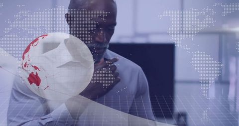 African American Businessman Analyzing Global Financial Data in Office