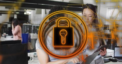 Coworkers collaborating on laptop and tablet with neon padlock overlay symbolizing cybersecurity