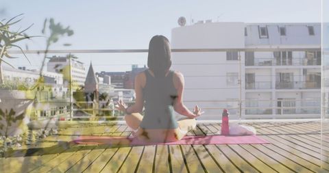 Woman Practicing Yoga on Urban Rooftop Terrace