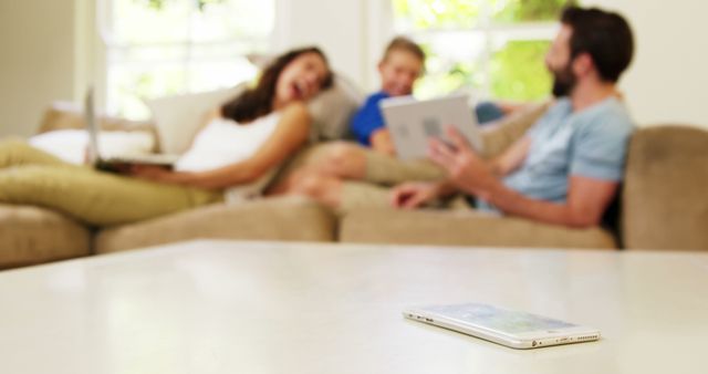 Family Relaxing on Couch with Digital Devices in Living Room - Download Free Stock Images Pikwizard.com