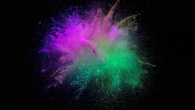 Vibrant Burst of Magenta and Green Powder in Motion