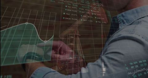 Musician Analyzing Digital Data While Tuning Guitar