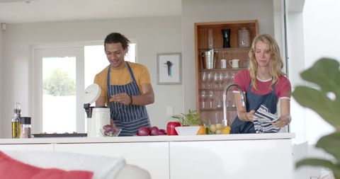 Cheerful Diverse Couple Preparing Meal in Modern Kitchen