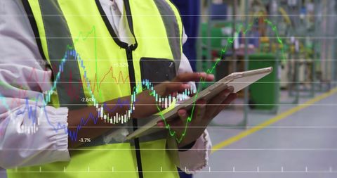 Engineer Analyzing Financial Trends on Digital Tablet