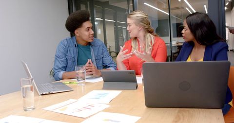 Diverse Colleagues Discuss Ideas in Modern Office