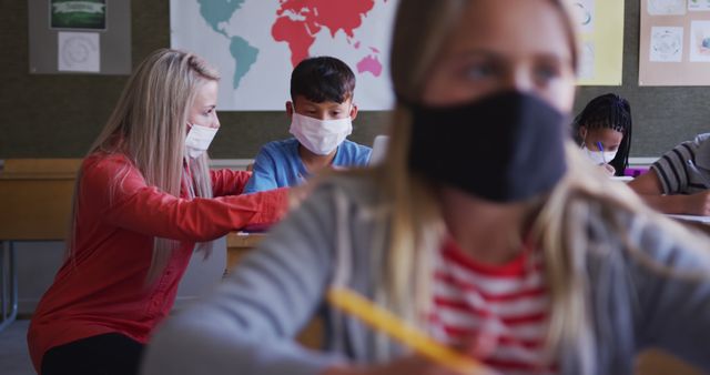 Teacher Wearing Mask Helping Students in Classroom - Download Free Stock Images Pikwizard.com