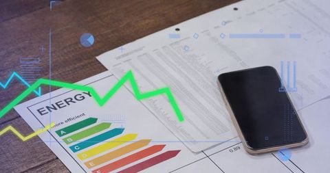 Showing energy efficiency report with smartphone and analytics overlay on wooden desk