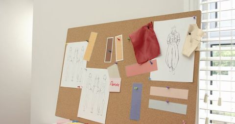 Fashion mood board displaying designer sketches, fabric swatches and color chips