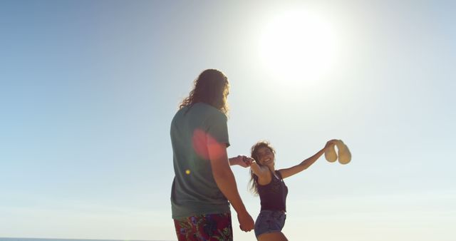 Happy Couple Enjoying Beach Vacation Under Bright Sunlit Sky - Download Free Stock Images Pikwizard.com