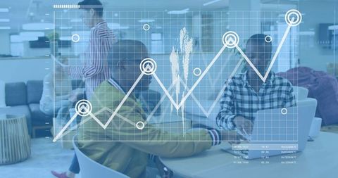 Collaborating on data analytics dashboard, colleagues working on laptops in coworking lounge