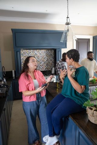 Diverse Friends Engaged in Conversation in Modern Kitchen