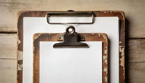 Rustic layered wooden clipboards with blank paper and vintage metal clips, flatlay
