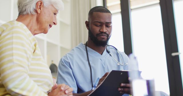 Nurse Consulting with Senior Woman in Home Environment - Download Free Stock Images Pikwizard.com