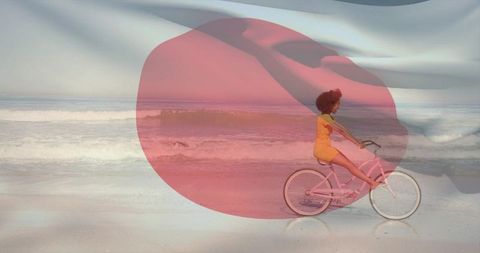 Woman riding pink cruiser on surf-swept beach with translucent red circle overlay