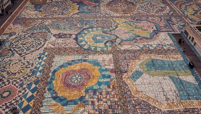 Aerial view of colorful tessellated mosaic pavement in urban plaza with geometric mandalas