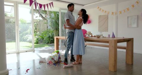 Father and Daughter Cleaning Party Mess at Home Amid Bonding Moment
