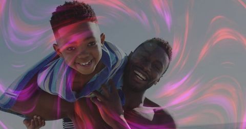 Joyful Bonding Between Father and Son in Vibrant Outdoor Setting