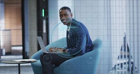 Professional Man Typing on Laptop in Modern Office Lounge