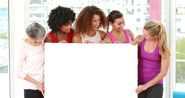 Diverse Group of Women Holding Blank Poster at Gym - Download Free Stock Images Pikwizard.com