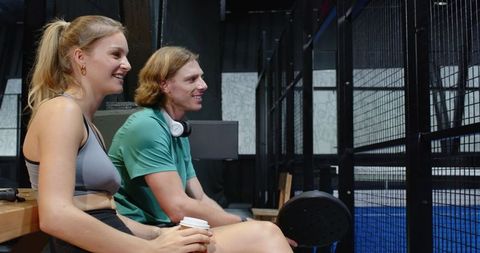 Friends Relaxing with Coffee at Padel Court