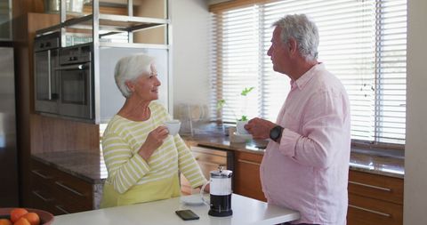 Senior Couple Enjoying Coffee and Conversation in Cozy Kitchen - Download Free Stock Images Pikwizard.com