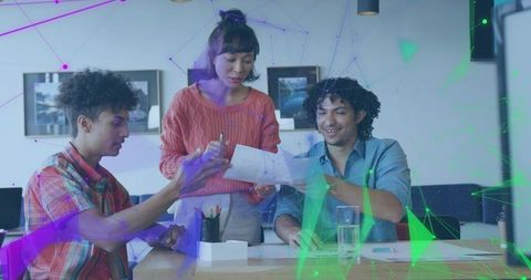 Diverse team collaborating at desk with digital network overlay and creative brainstorming