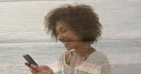 Smiling Woman Using Smartphone at Beach on Relaxing Day