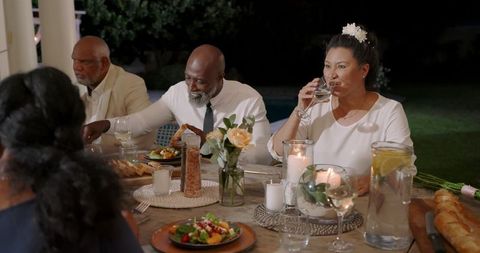 Senior Friends Enjoying Backyard Wedding Dinner Party