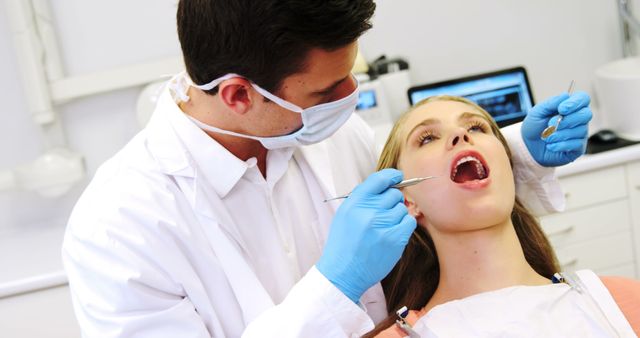 Dentist Examining Female Patient's Teeth in Modern Dental Clinic - Download Free Stock Images Pikwizard.com