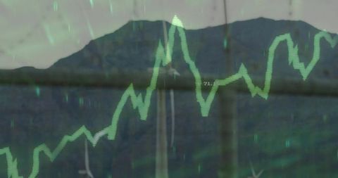 Green energy graph overlay on wind farm mountain background
