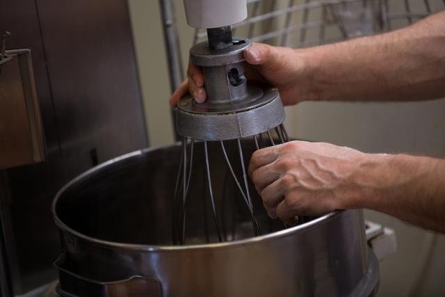 Close-up of hand adjusting dough machine