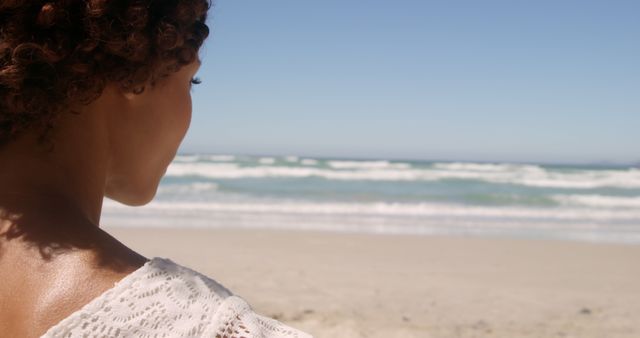 Woman Relaxing by Tranquil Ocean Beach on Sunny Day - Download Free Stock Images Pikwizard.com